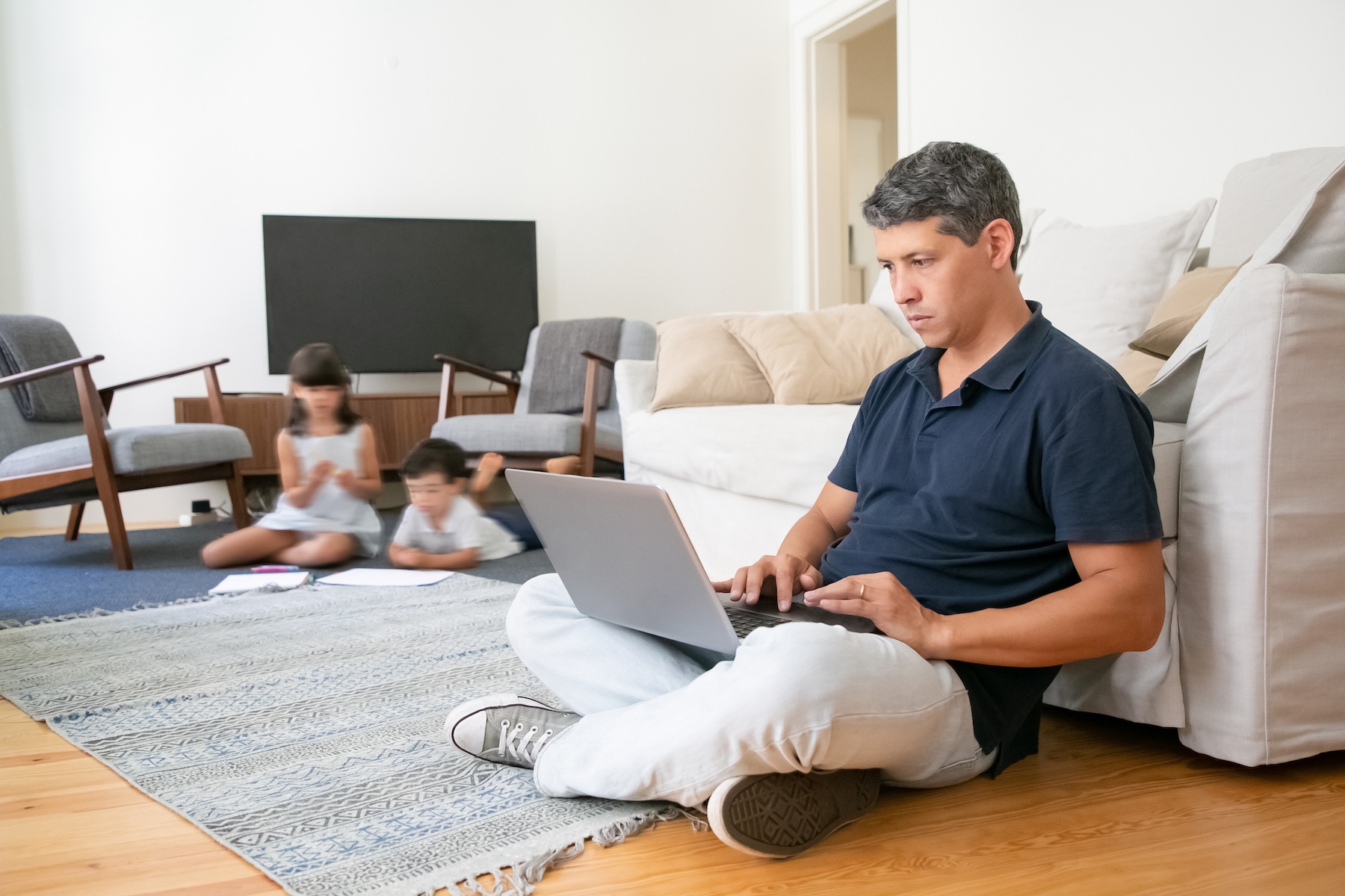 man working with kids in the background